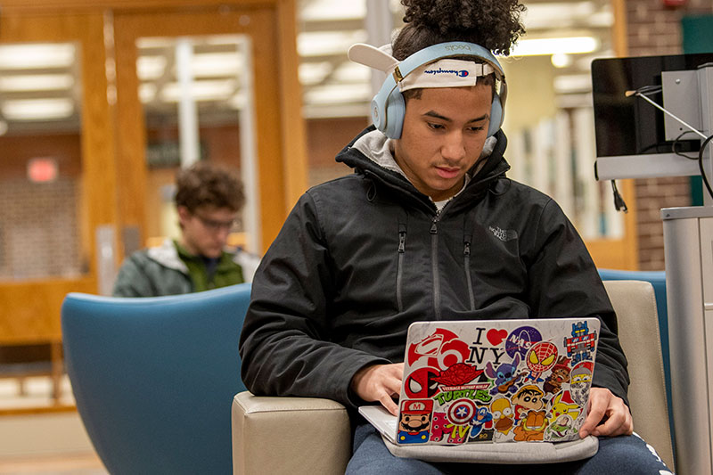 Student studying at the Homer Babbidge Library