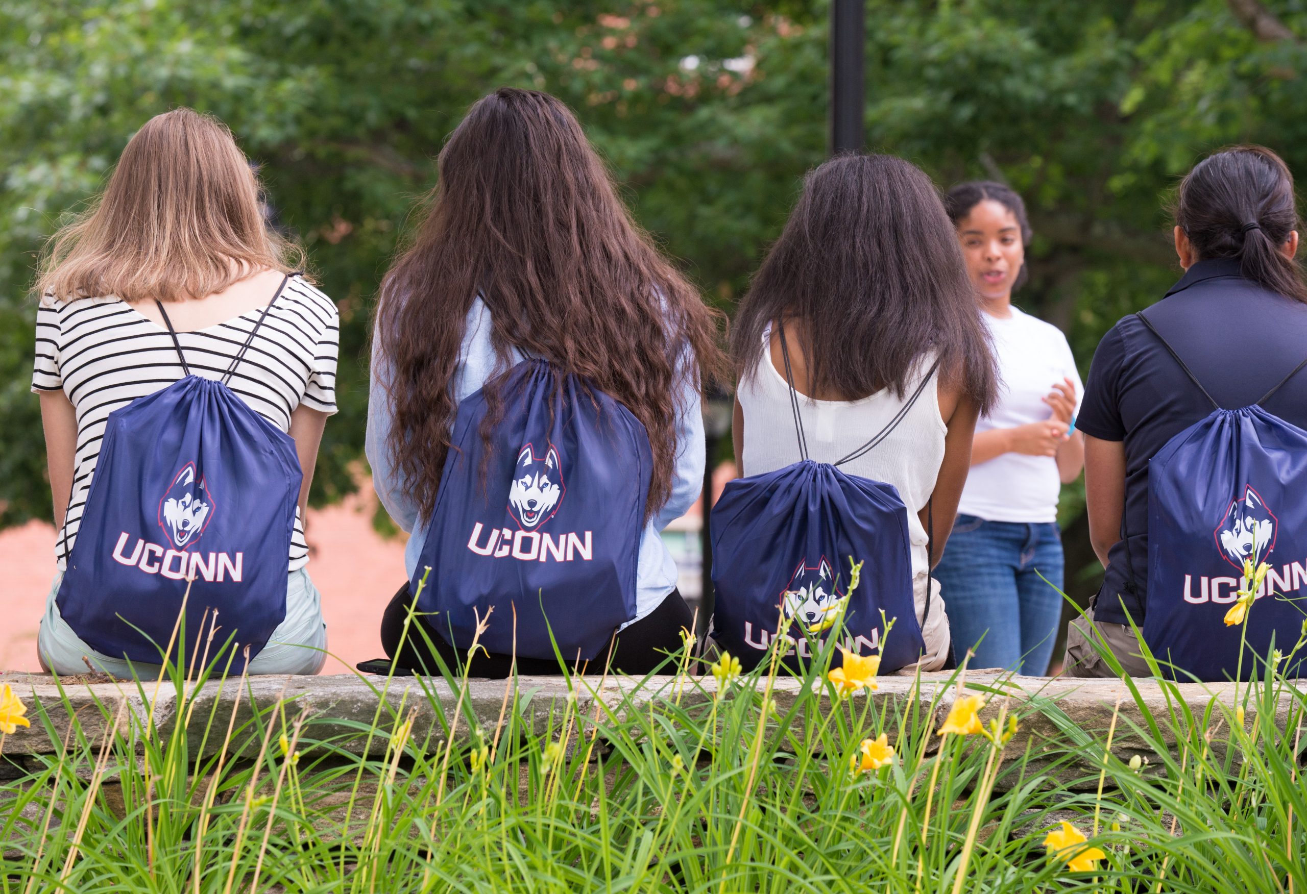 Uconn students wearing upon backpacks