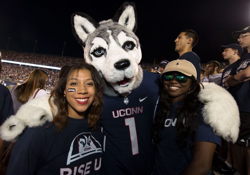 UConn mascot and fans at football game
