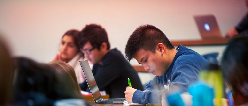 student studies among other classmates