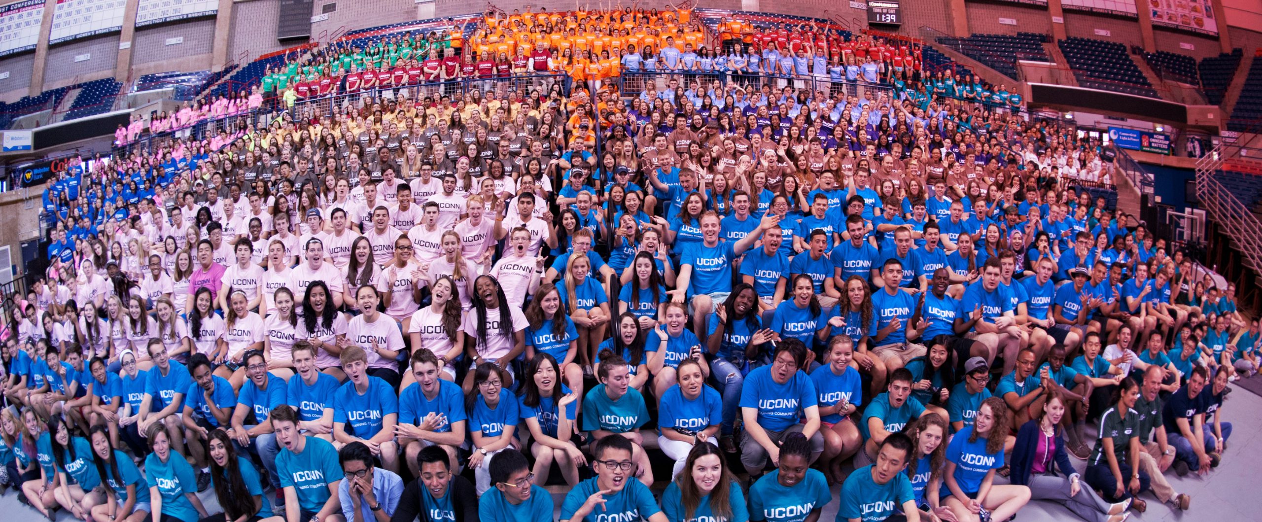 a hundred plus students gather together for the Learning Communities kickoff at Gampel Stadium