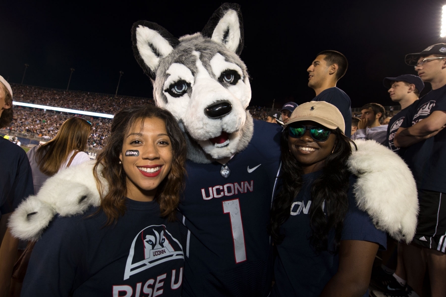 UConn mascot and fans at football game