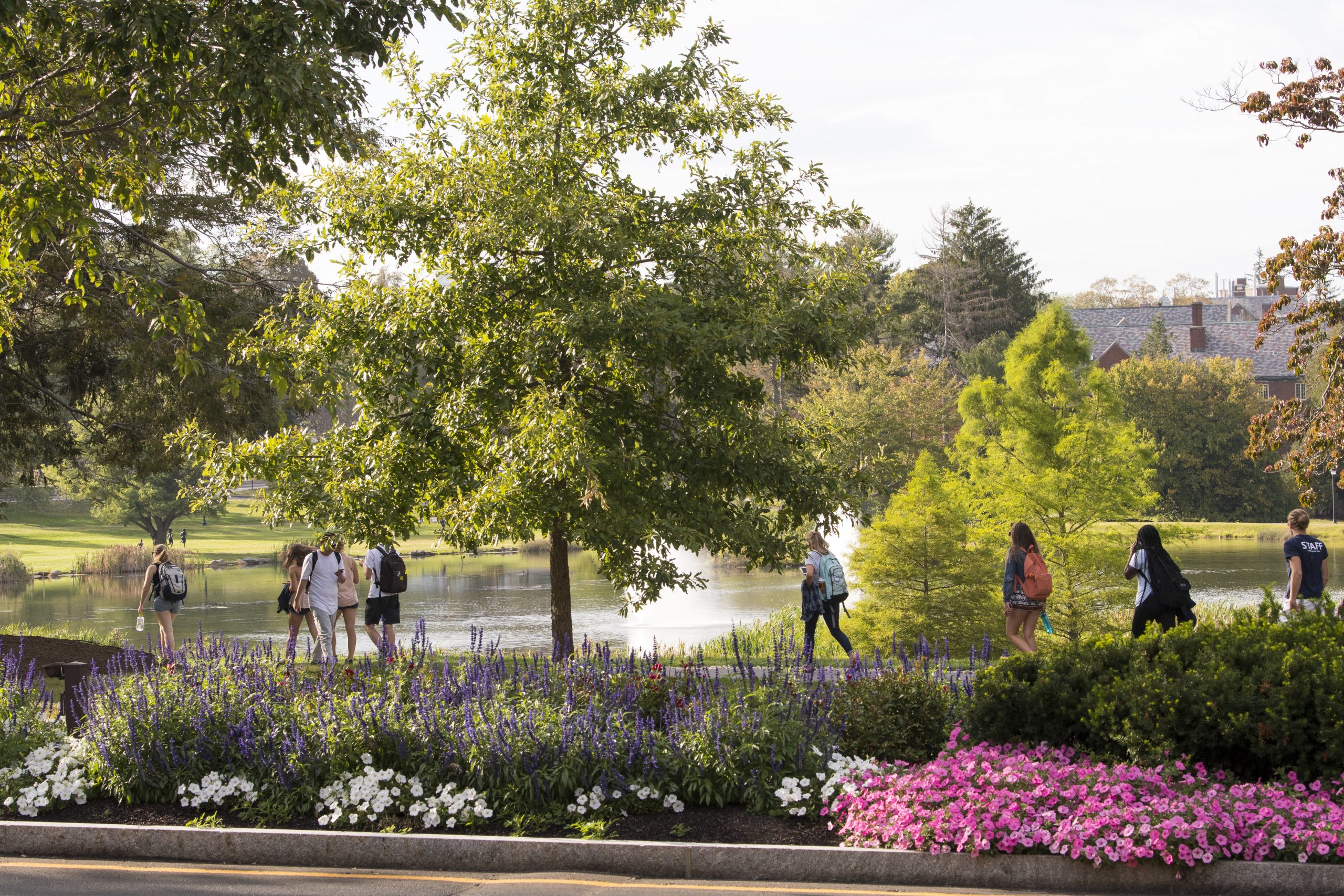 Students walk near Mirror Lake on the Storrs Campus