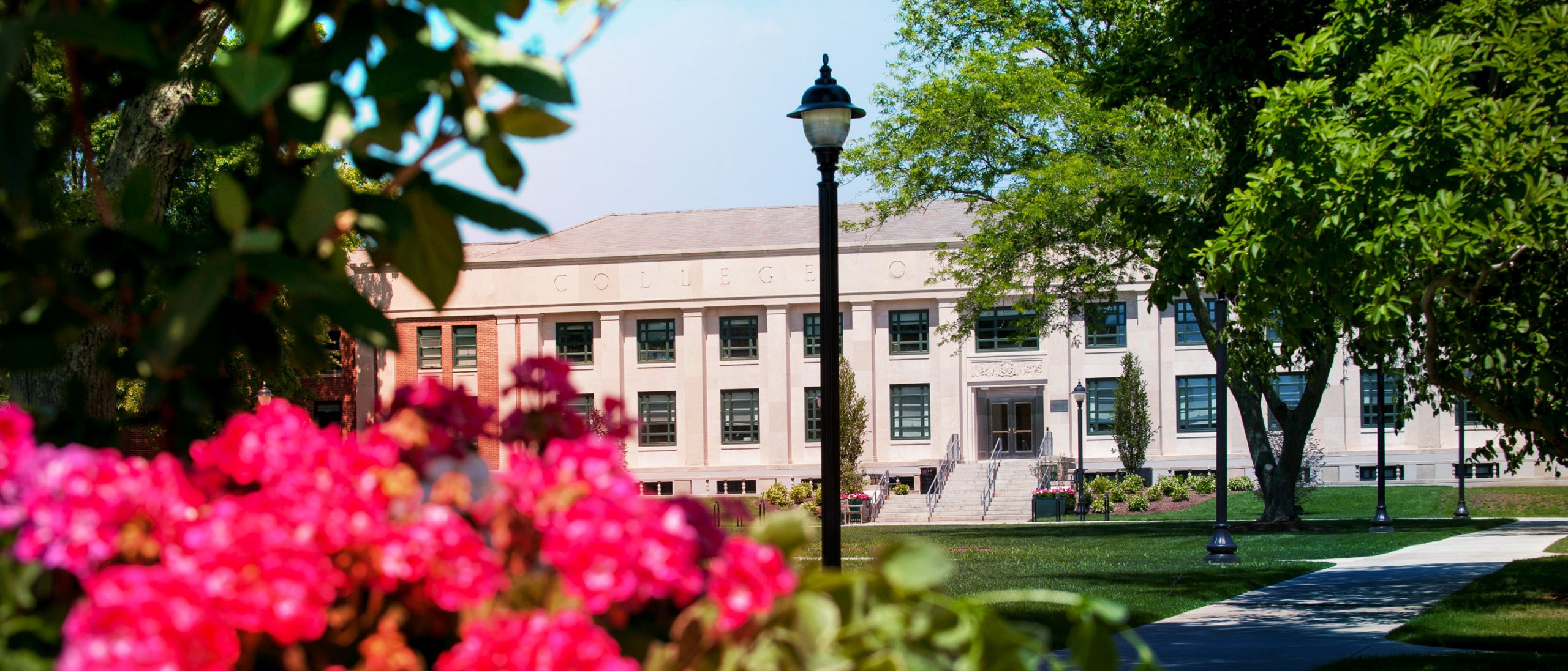 the College of Agriculture, Health and Natural Resources building spotted behind blooming flowers