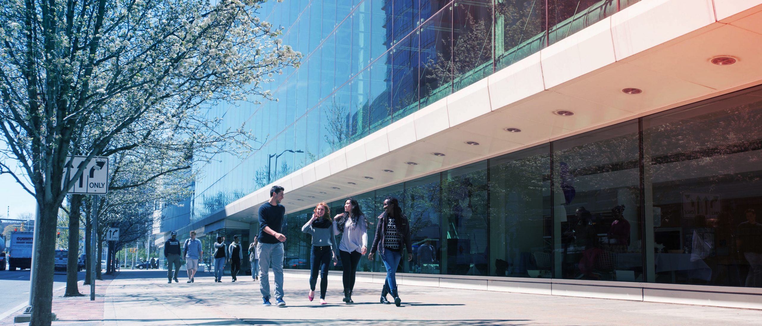 UConn students walk in a group in stanford campus