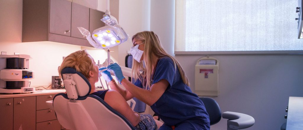 person preforms dental work