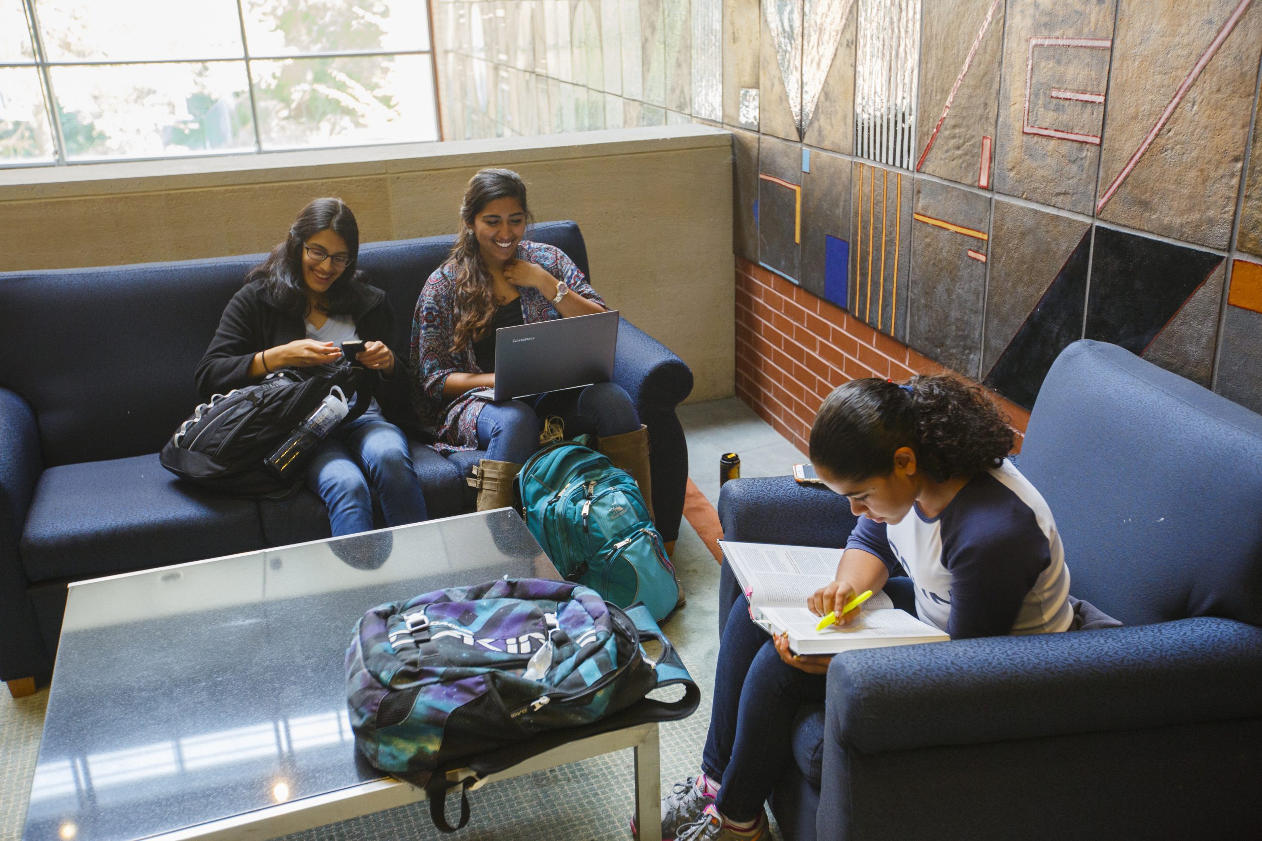 students gather and study on couches