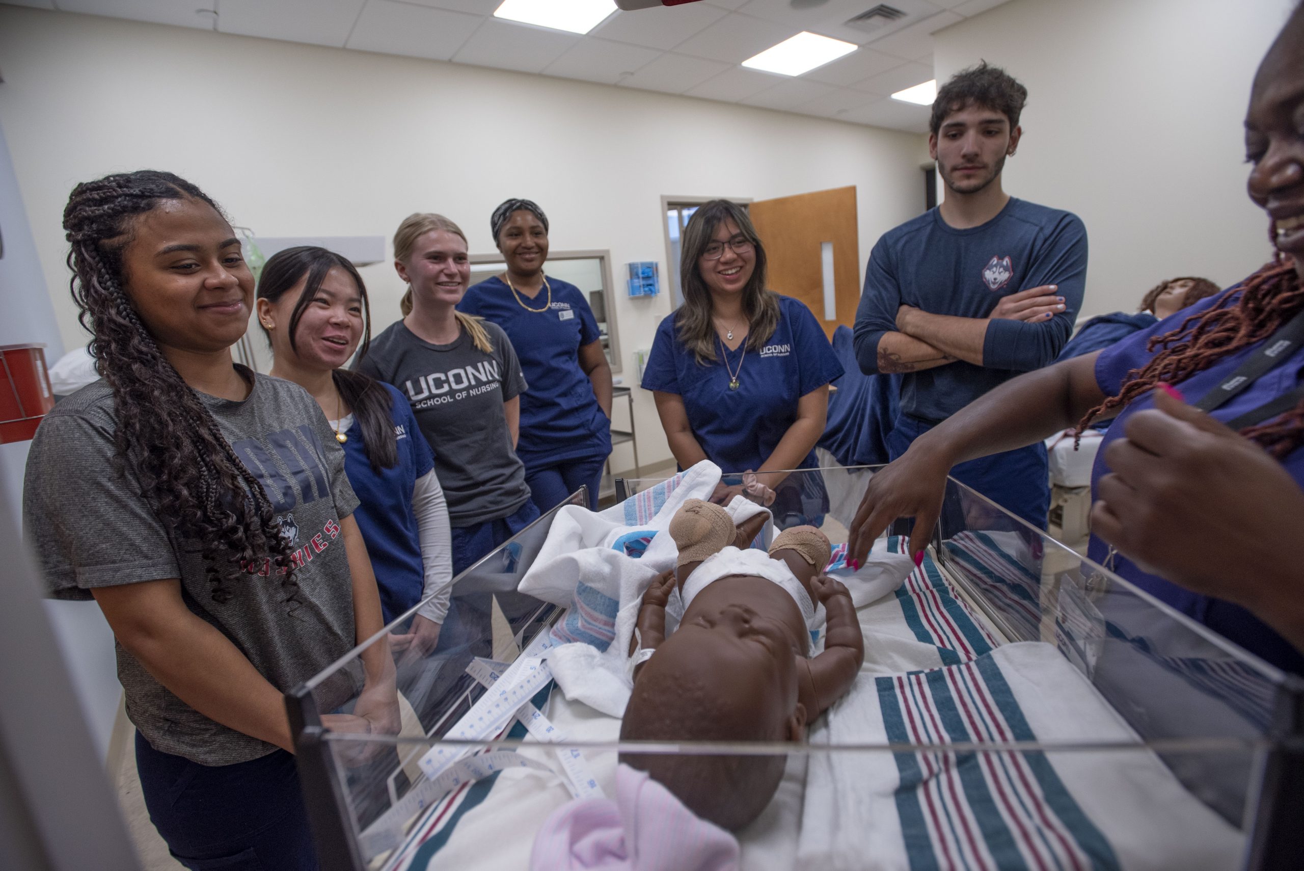 students learning about infant care in the school of nursing simulation lab