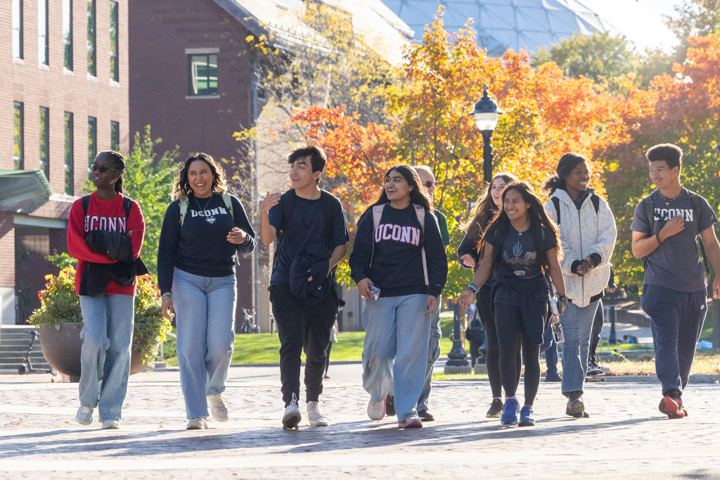 UConn students walk down Fairfield Way among the fall foliage